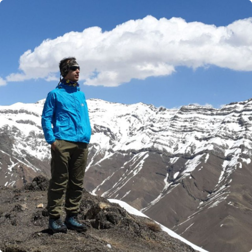Morty standing in front of snow-covered mountains